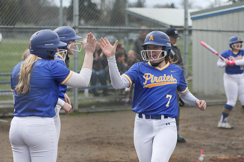 Adna's Alyssa Carroll (7) high-fives Kendall Humphrey after scoring a run during Adna's win over PWV on March 31.