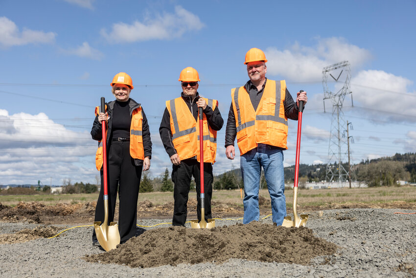 From the left, Port of Chehalis CEO Lindsey Senter, Port of Chehalis Commissioners Mark Anders and Paul Ericson pose for a photo during a groundbreaking ceremony for the construction of a public grain storage and transloading facility in Chehalis on Thursday, April 3.