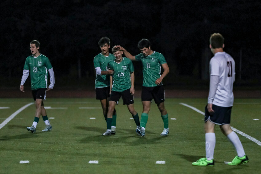 Tumwater's Malachi Vuong (12) and Dylan Stevens (11) celebrate with Kaydon Hanks (25) after he scored a goal during a soccer game against Black Hills at Tumwater High School on Tuesday, April 8.