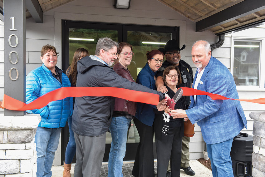 La Center Mayor Tom Strobehn, left, cuts the ribbon alongside Police Chief Phil Sample, city council members and city staff on Monday, April 7. The ceremony marked the official reopening of the Wheel Club Community Center following its $322,500 remodel.