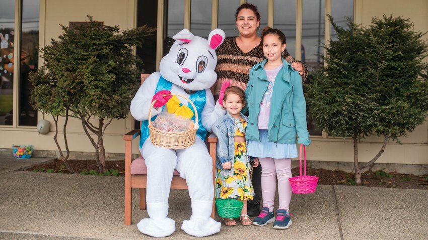 Dublin Duckett smiles for a photo with the Easter Bunny alongside Jade, 7, and Alanna, 2, outside the Sticklin Funeral Chapel in Centralia in 2022.