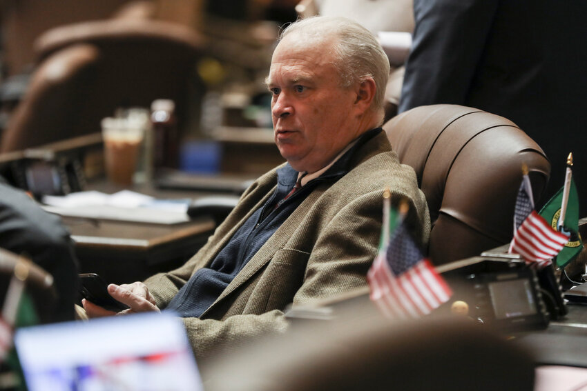 State Rep. Jim Walsh, R-Aberdeen, listens to another legislator during the 93rd day of the legislative session on the House floor of the Washington state Capitol on Tuesday, April 15.