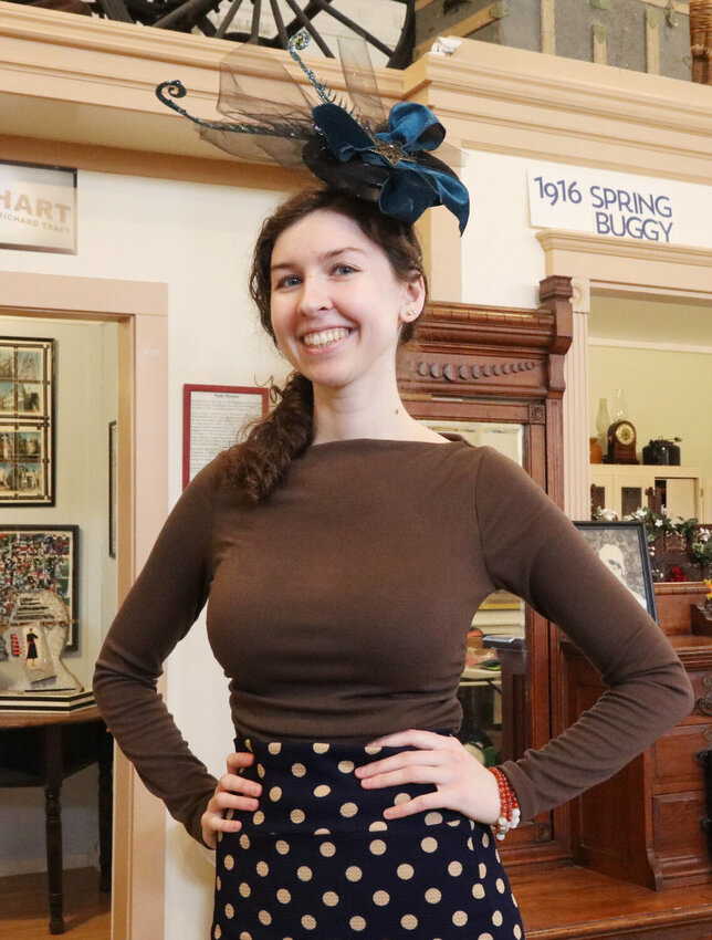 Madeline Elliott poses for a photo while wearing her fascinator headpiece at the Lewis County Historical Museum in Chehalis on Saturday, March 23, 2024.