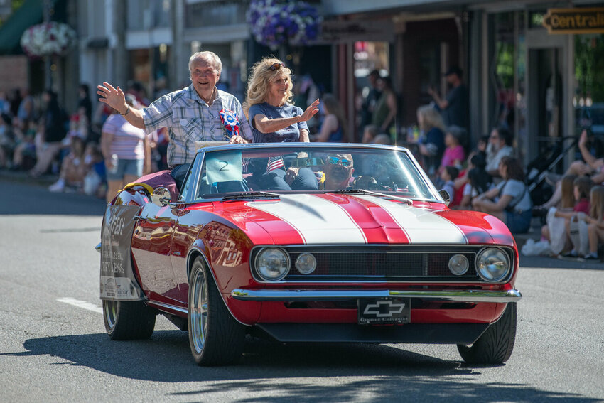 Parade grand marshals Jerry and Eileen Owens wave from a car during Centralia's annual Summerfest parade on July 4, 2024.
