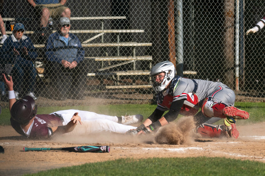 Tenino's Austin Gonia tags out a runner at the plate during a doubleheader in Montesano on April 18.