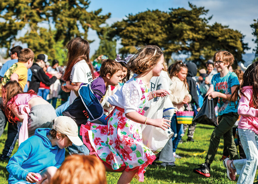 Children run in search of Easter eggs in the age 9 to 11 group on Saturday, April 19, during the Woodland Moose Lodge Easter Egg Hunt at Horseshoe Lake Park.