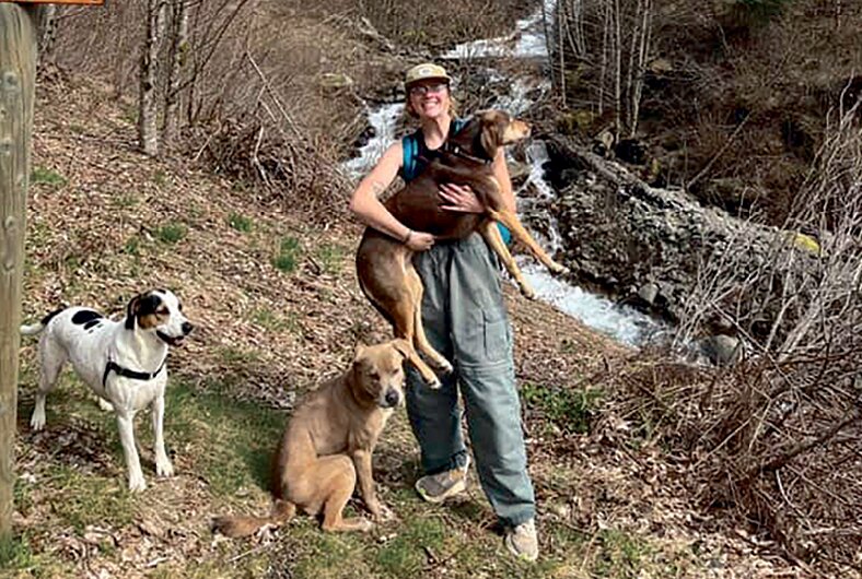 Emma Mathson, her friend and their three dogs pose for a photo with their search and rescue team while on a hike to Coldwater Lake on April 10.