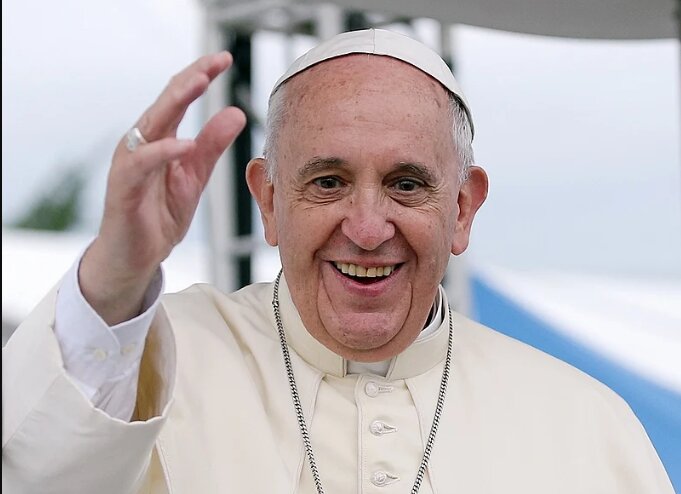 Pope Francis smiles and waves in this photo from 2014.