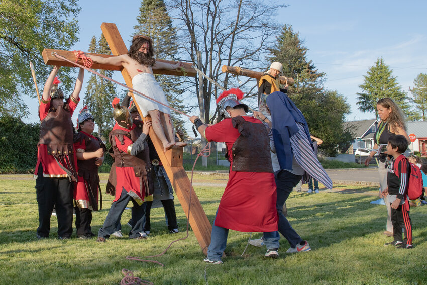 Crosses are lifted during the Stations of the Cross ceremony outside St. Mary&rsquo;s Church in Centralia on Friday.