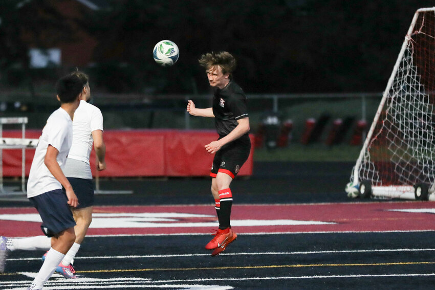 Tenino's Zach Ash heads the ball out of the Tenino zone during Tenino's shootout loss to Forks on April 21.