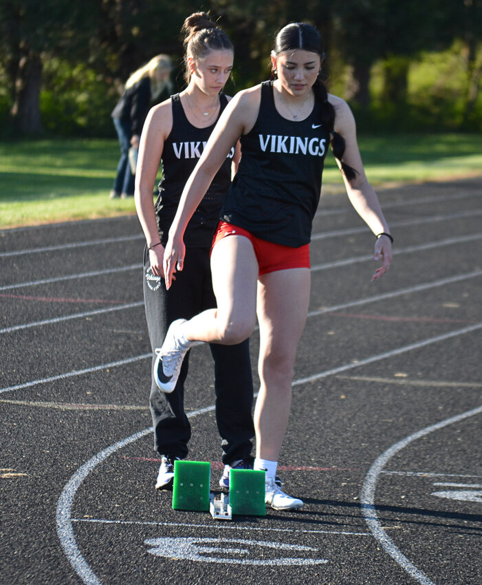 Mossyrock's Saydi Mendoza (front) and Avery Tienhaara prepare for a race during the high jump at a meet in Mossyrock on April 22.