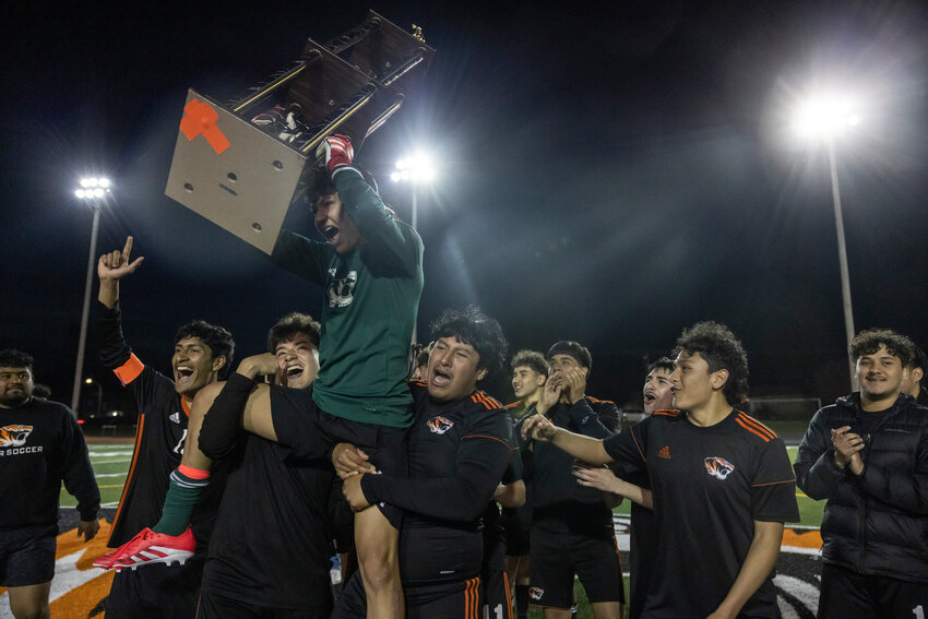 Centralia's Alejandro Arevalo (1) holds up the Chronicle Cup trophy after defeating W.F. West at Centralia High School on Friday, April 25.