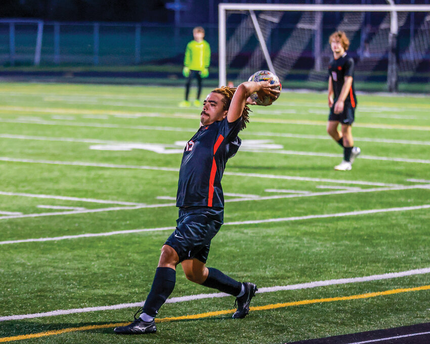 Battle Ground Tigers' senior soccer player Kingston Gaither throws the ball from the sidelines in the second half of the Tigers' 4-1 loss to Union High School on Wednesday, April 23.
