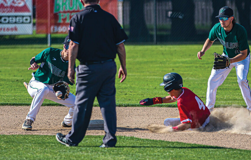 R.A. Long baserunner Carson Libby (4) slides into second base just ahead of the tag by Woodland shortstop Jackson Andres while second baseman Jake Sams backs up the play during a league matchup against Woodland on Wednesday, April 23, at The Lumberyard. The Lumberjacks went on to win 6-0.