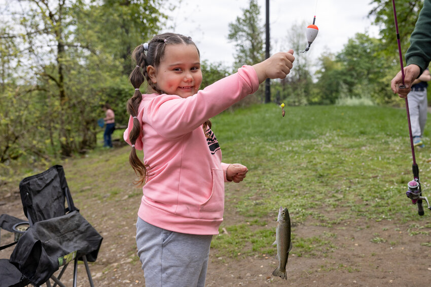 Ariela Arteaga poses for a photo with her first fish during a youth fishing derby at Fort Borst Pond on Saturday, April 26. The derby, for ages 3 to 12, was sponsored by the Centralia Lions Club and included a prize drawing for those who signed up. Hot dogs and milk were given to participants.