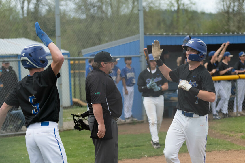 Adna's Ty Bodenhamer (7) high-fives Mat Roundtree (5) after they both scored during Adna's win over Napavine on April 28.