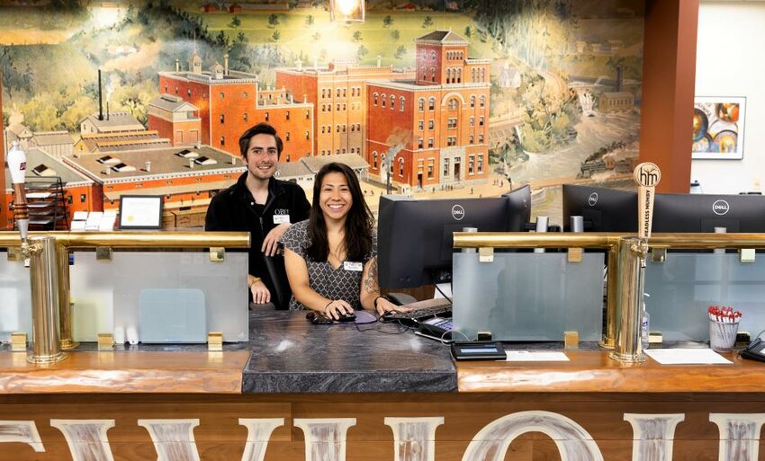 Two O Bee Credit Union staff members are pictured behind the counter.