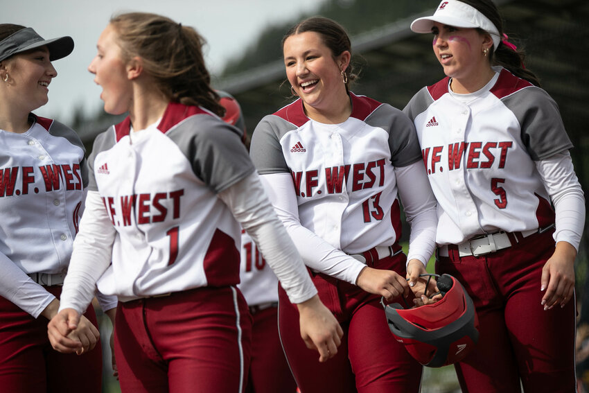 W.F. West's Karlee Coleman (13) smiles after hitting a three-run home run against Aberdeen during an Evergreen Conference game on Friday. May 9 at Recreation Park.