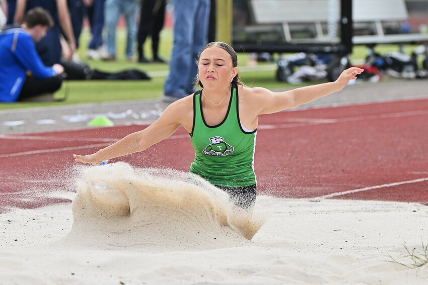 Tumwater's Ashlyn Hufana leaps into the long jump pit at Friday's 59th Shaner Invite at Tumwater District Stadium.