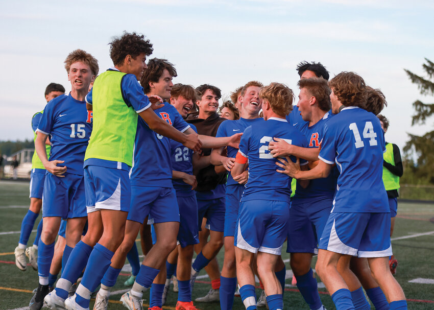 The Ridgefield Spudders boys soccer team celebrates around Carson Young after his game-winning goal in PKs over the Centralia Tigers on Thursday, May 8, to extend the Spudders&rsquo; season into the 2A District 4 Tournament.