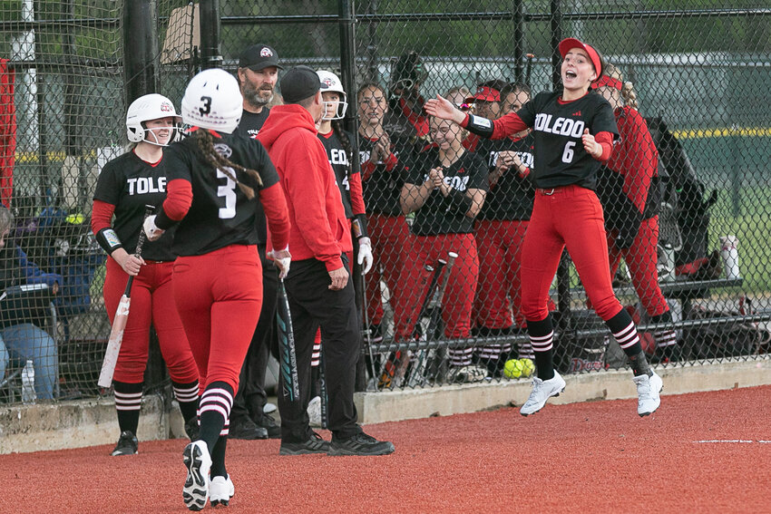 Toledo's Zaya Norberg (6) celebrates as Xtyn Norberg (3) returns to the dugout after hitting an inside-the-park home-run during Toledo's 15-0 win over North Beach in the first round of the 2B District 4 Tournament at Fort Borst Park on May 12.