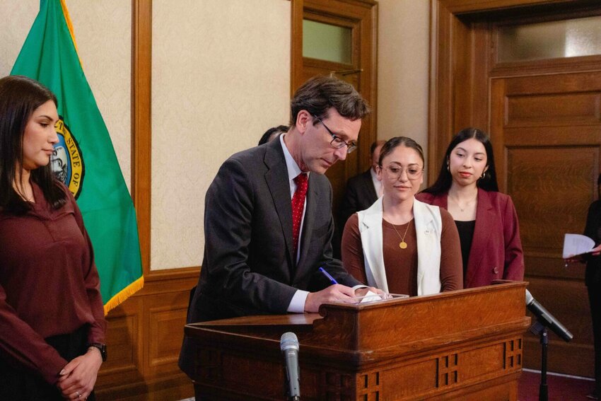 Gov. Bob Ferguson signed a trio of bills on Monday related to protecting immigrants in Washington state. (Photo by Jacquelyn Jimenez Romero/Washington State Standard)