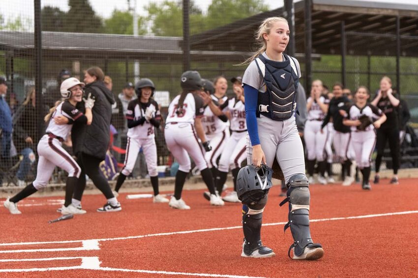 Adna&rsquo;s Danika Hallom walks off the field as Ravens players celebrate after a 10-0 District 4 Tournament Semifinal loss to Raymond-South Bend at Fort Borst Park in Centralia on Wednesday, May 14.