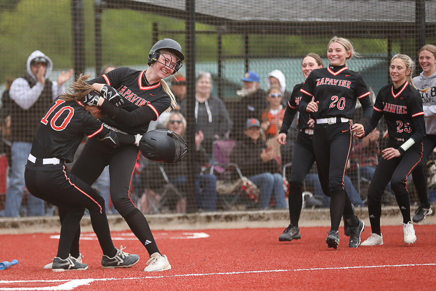 Napavine's Dakota Lyons (10) is mobbed by Hayden Kaut and her teammates after scoring the walk-off run of Napavine's win over Toledo during Day 2 of the 2B District 4 Tournament at Fort Borst Park on May 14.