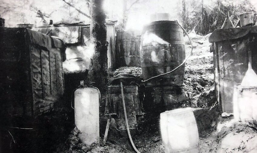 FROM THE ARCHIVES: This 1920s photo of a moonshine still was taken in an area behind the Seminary Hill property of James A. and Mary A. Smith. James E. Smith, their son, took this photo when the moonshiner was away. It was obviously taken prior to the end of Prohibition. The moonshiner once explained to the Smiths that he didn't consider himself an outlaw but rather a man with a skill — providing a product that was in demand. He said his moonshine was considered "the best by working folk and the Who's Who of Centralia."
— Information and photo originally submitted by James E. Smith for Our Hometowns.