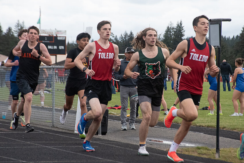 Treyton Marty of Toledo, middle, prepares to make his winning move in the 1600 at the Central 2B League championships at Rainier High School on Friday, May 16.