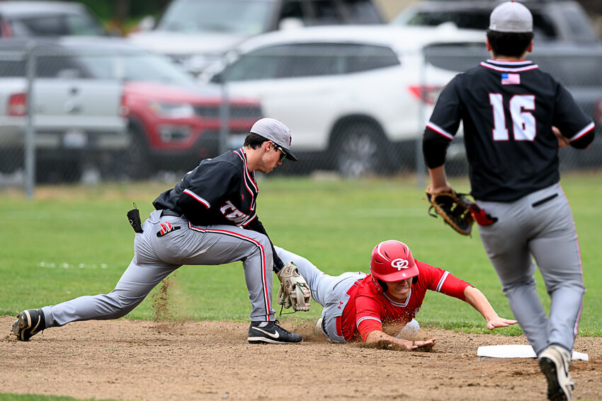 Tenino's Will Feltus reaches to tag out a runner during Tenino's loss to Castle Rock in a 1A District 4 Consolation Semifinal in Castle Rock on May 16.