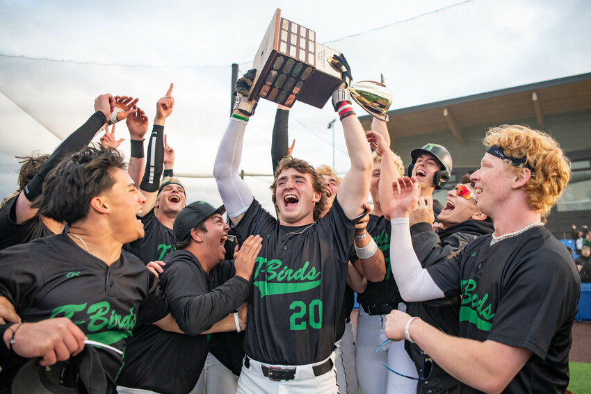 Tumwater&rsquo;s Derek Thompson lifts the District 4 trophy after hitting a walk-off home run to win the 2A District 4 Championship over W.F. West at Ridgefield Outdoor Recreation Complex on Saturday, May 17.