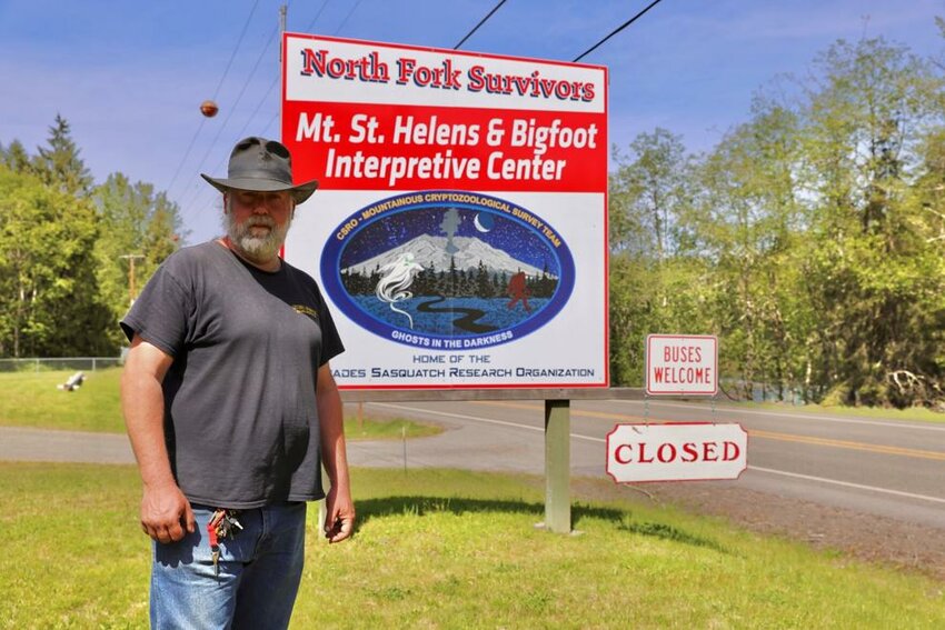 North Fork Survivors owner Joe Bongiovanni poses for a portrait by his museum sign Tuesday, May 6 in Toutle. Bongiovanni says the Washington State Department of Transportation's signage for road closure has impacted his business, not the actual road closure.