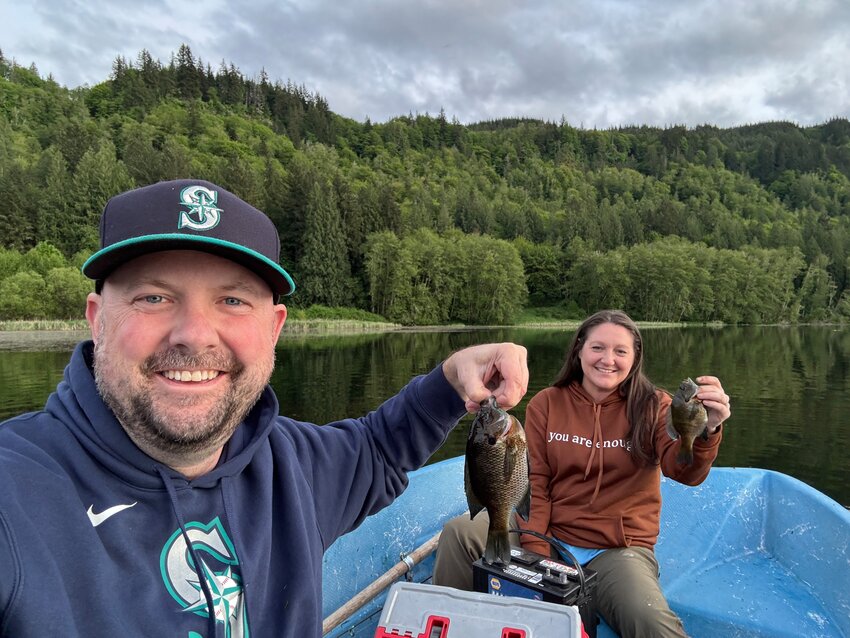 Chris and DeeDee Judd hold up their catches of bluegill during a recent fishing outing at Swofford Pond.