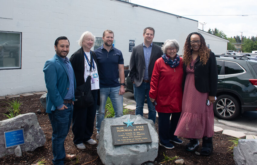 From left to right, Mayor Joe DePinto, Dee Smith, Joel Sponton, Will Quinby, Judy Swortz and Pastor Georgie Brown pose behind the new Blue Star Memorial by-way marker outside Tim's Pharmacy on Saturday, May 17.