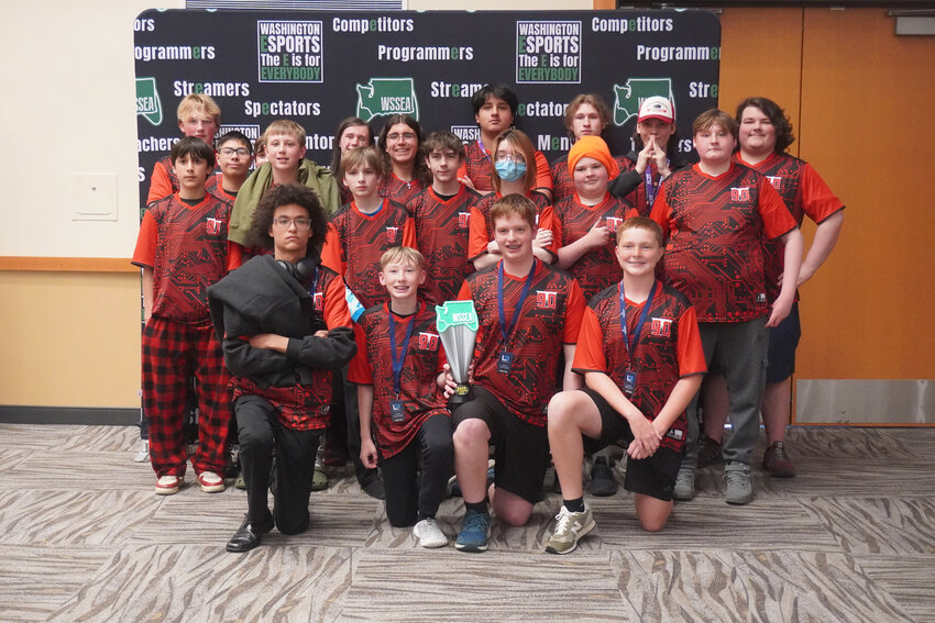 The Tenino High School esports team poses for a photo with the "Rocket League" state championship trophy at the Washington State Scholastic Esports Association High School State Championships at the Lynnwood Event Center on Sunday, May 18.