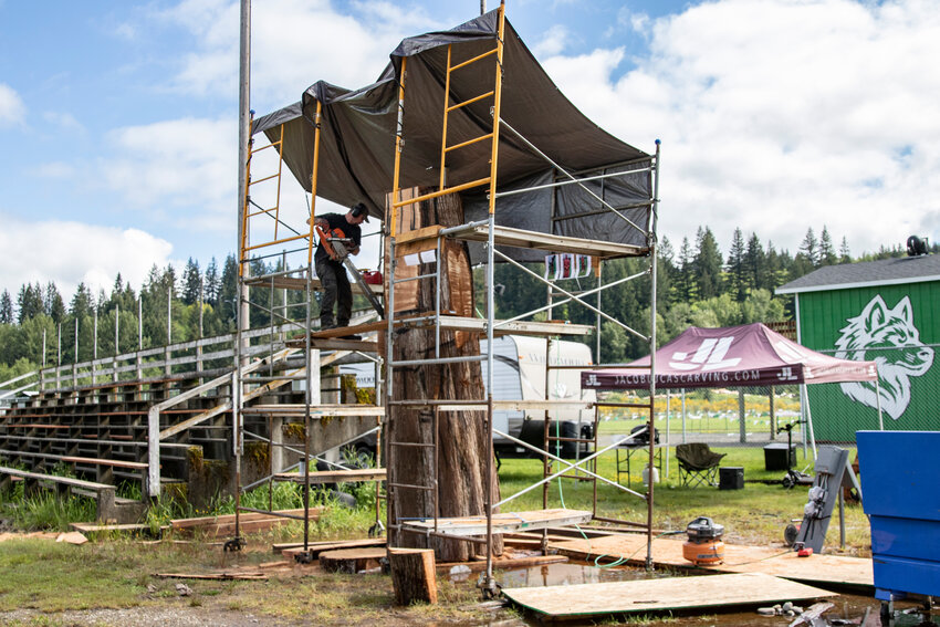 Wood carving and chainsaw artist Jacob Lucas chainsaws parts of a cedar log at the Loggers&rsquo; Jubilee Arena in Morton on Wednesday, May 21.