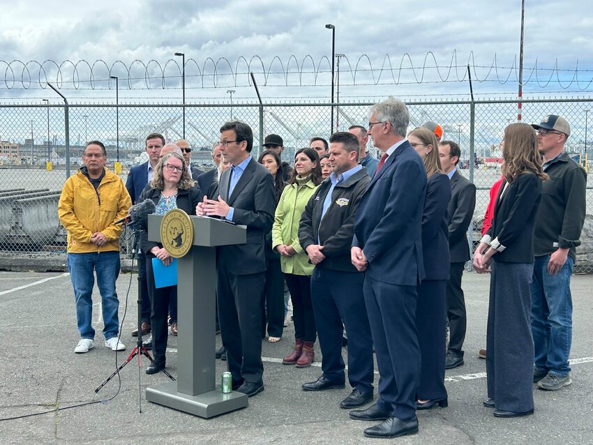 Gov. Bob Ferguson slams President Donald Trump’s tariffs in a press conference alongside union leaders, lawyers, elected officials and others at the Port of Seattle on Wednesday, May 21, 2025. (Photo by Jake Goldstein-Street/Washington State Standard)