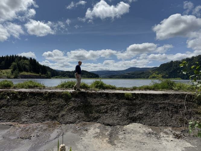 Karl Ahlen, current Corps' Project Manager for the Sediment Retention Structure, stands facing the dam's spillway on Wednesday, May 21. It was built in response to the Mount St. Helens eruption.