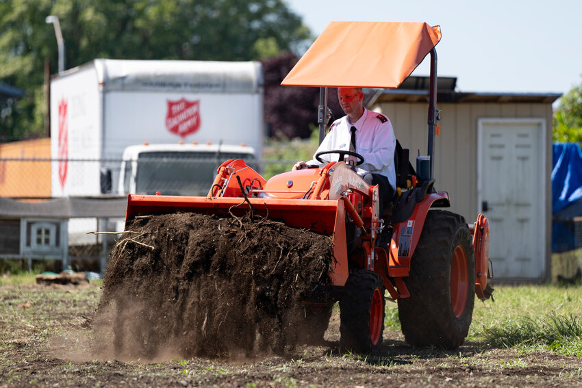 Salvation Army Captain Steven Pack uses a tractor to spread compost at the Harvesting Hope Farm at the Centralia Salvation Army on Wednesday, May 28.
