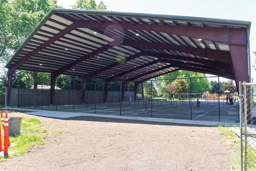 Construction crews surface the pickleball courts at Kiwanis Park. The courts are nearly finished and feature a cover and sound barrier but remain closed to the public.