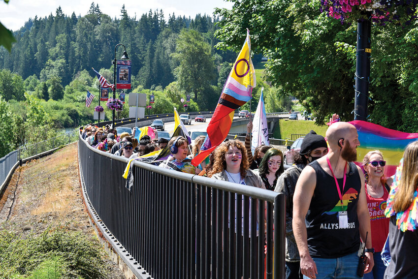 Around 200 people participating in Clark County Pride&rsquo;s Rainbow Walk cross the East Fork Lewis River Bridge into downtown La Center. The event marked the fifth annual walk to celebrate Pride Month and promote LGBTQ+ visibility in rural Clark County.