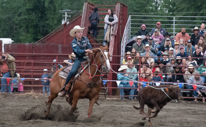 Jace Harris and his horse, Jonny, compete in the calf roping event at the Roy Pioneer Rodeo on Saturday, May 31.