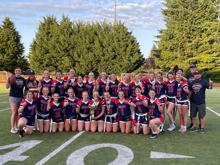 The Black Hills flag football team poses for a photo with the trophy after winning the &quot;mini-season&quot; tournament at Tumwater District Stadium on June 3.