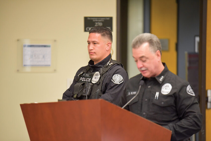 Detective Ethan Poki listens as Battle Ground Police Chief Dennis Flynn outlines Poki&rsquo;s investigative leadership and why fellow officers voted him Officer of the Year.