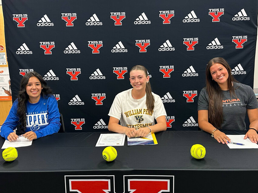 Yelm High School athletes Salma DIaz (left), Austin Hitchner (center), and Layah Hicks (right) smile for a photo on Friday, June 6 as they celebrate their ceremonious signings.