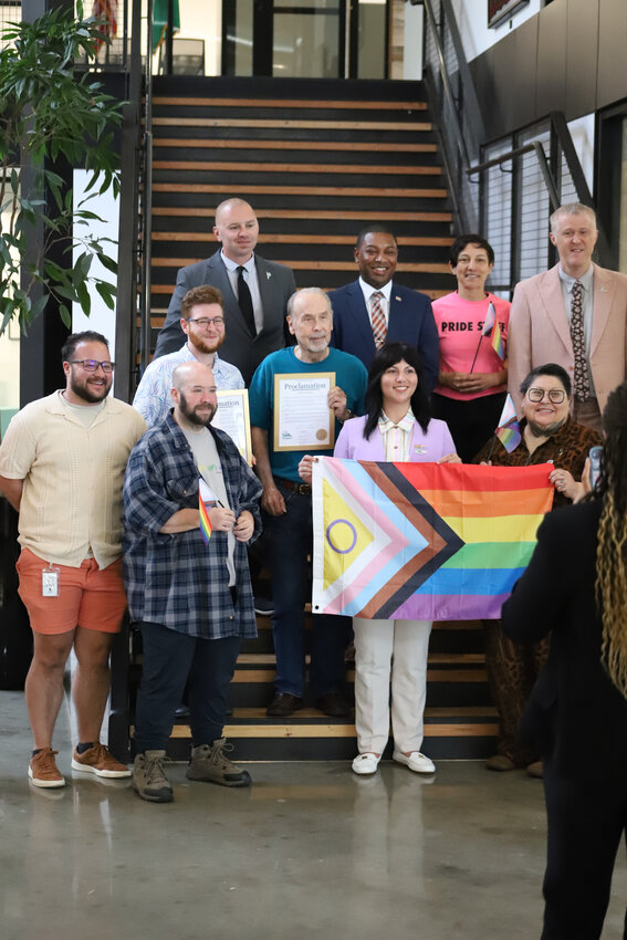 Natalie Copeland, left, and Quinn Snow applaud after the Thurston County Commissioners proclaim June as LGBTQ+ Pride Month at the Thurston County Board of County Commissioners meeting on Tuesday, June 3.