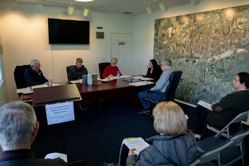 Seated at the table from the left, Port of Centralia Commissioners Peter Lahmann, Kyle Markstrom and Julie Shaffley discuss new proposed public records request policies and procedures with Port attorney Ray Liaw and Port Executive Director Kyle Heaton during the Port commissioner's Wednesday, Feb. 5, regular meeting.