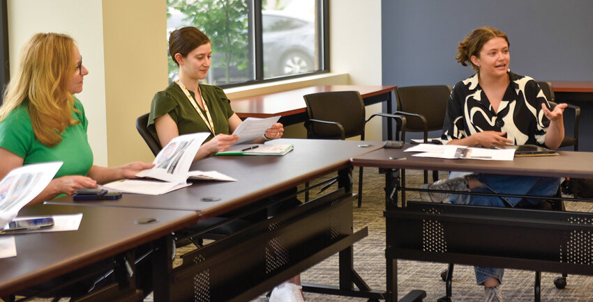 Ana Honsowetz (right), a muralist and designer, explains her preliminary mural concepts for Kiwanis Park's pickleball court sound wall to PACE board members during a June 11, 2025 meeting.