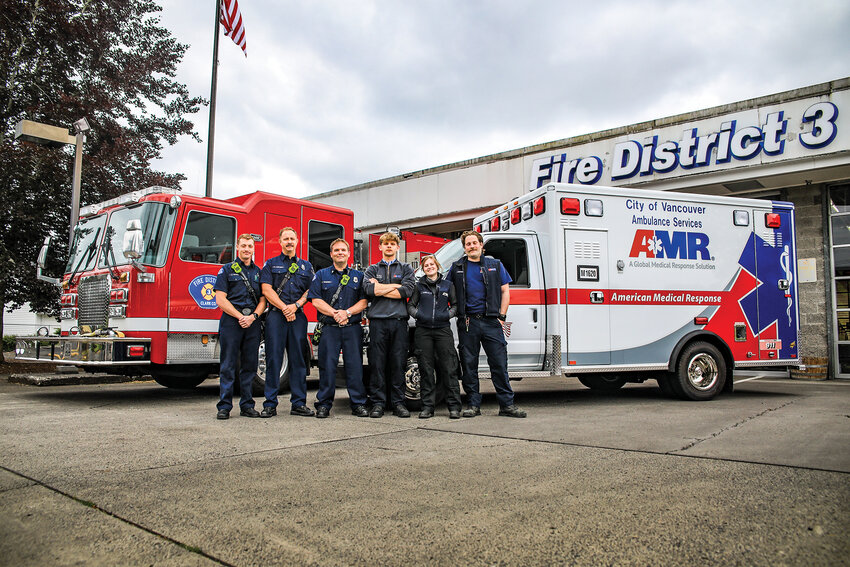 The initial responding Clark County Fire District 3 and American Medical Response (AMR) crews stand in front of Station 35 in Battle Ground after recounting a dual emergency situation between a medical emergency and house fire across the street from the initial medical call on Tuesday, June 10. From left to right are firefighter/paramedic Jerik Traffie, firefighter Tim Axelson, Captain EMT Charlie Campbell, AMR paramedic Ruben Kovalenko, AMR paramedic Camille Burgess and AMR medic Adam Lengvenis.